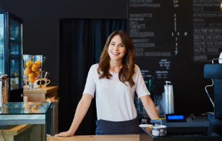 Woman Standing Behind a Table