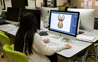 Female student working on a computer. 