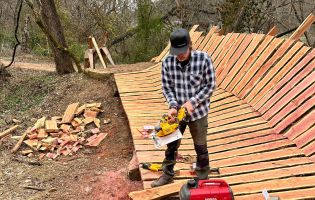 Man Holding a Tool on a Wooden Trail