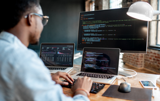 Person writing code on a computer