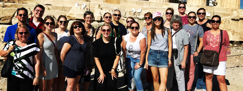 Group of People In Front of Greek Ruins