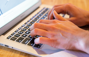 Hands Typing on a Computer